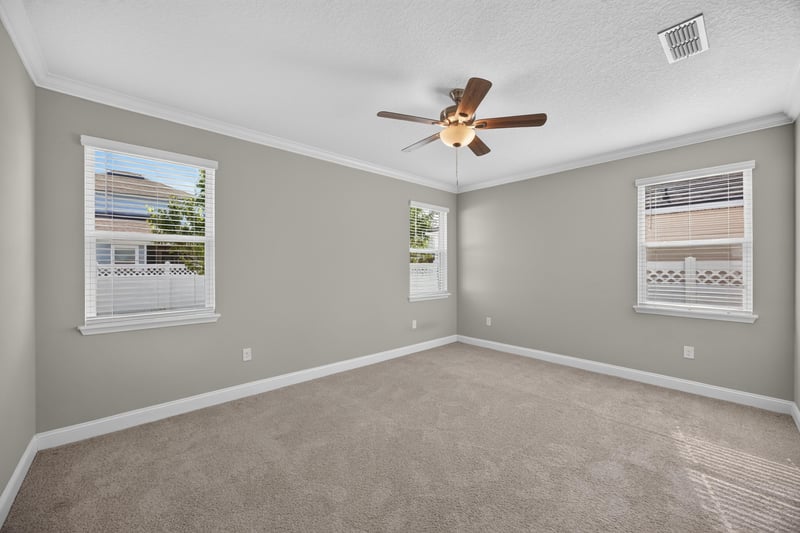 Bedroom with carpet and two windows at 331 Millerstone Dr, St. Augustine, FL 32092