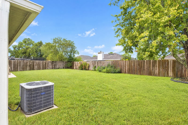 Backyard patio with covered area and AC unit at 11197 Illford Dr