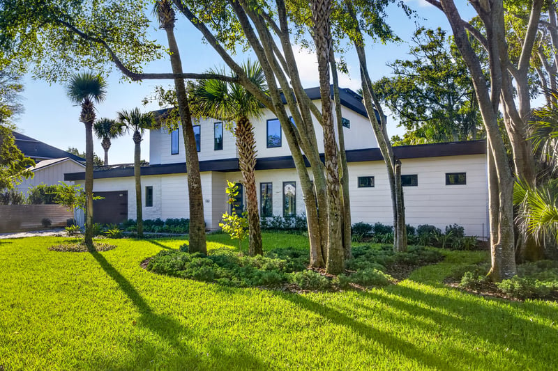 Front exterior framed by mature trees at 722 3rd Ave N, Jacksonville Beach, FL