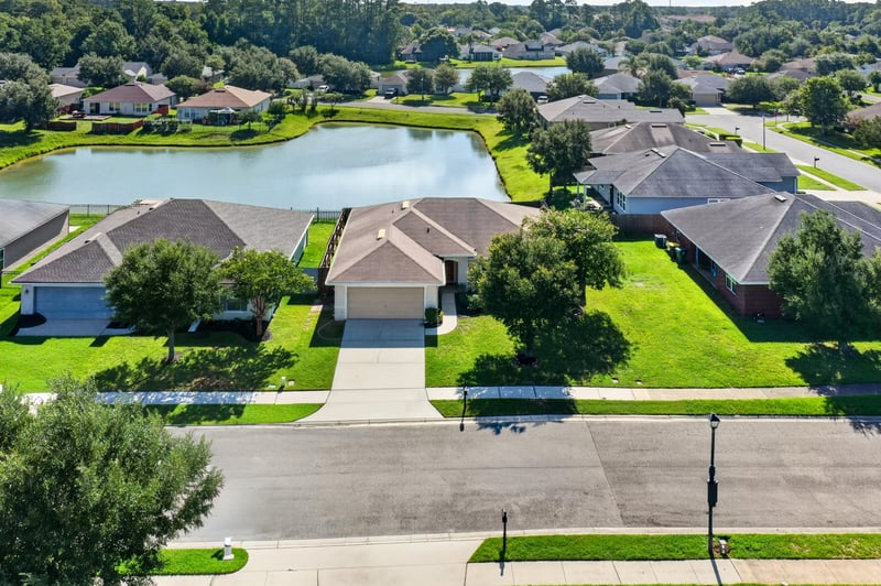 Aerial day view of the home along the street at 7545 Lirope St, Jacksonville, FL 32244
