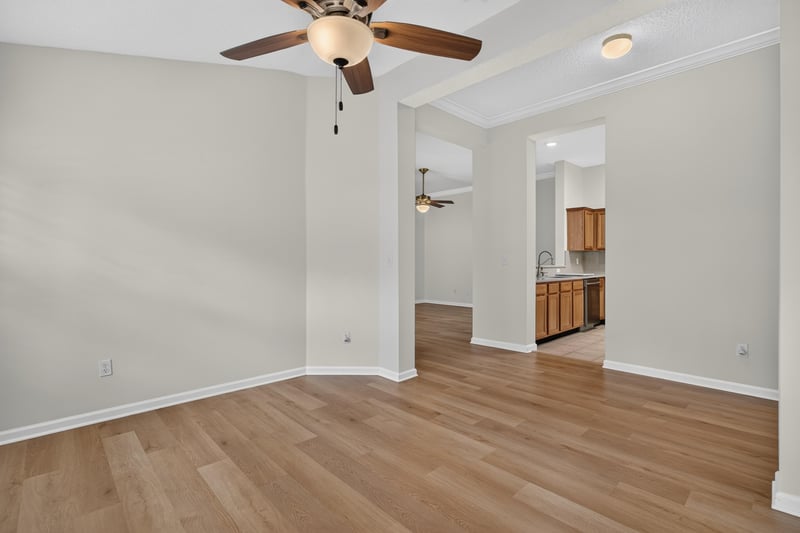 Room with ceiling fan opening to the kitchen at 2131 E Stone Creek Dr, Fleming Island, FL