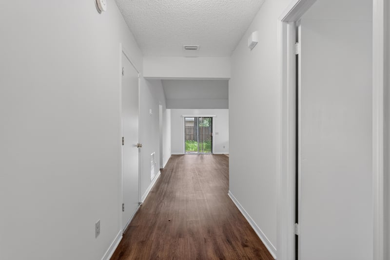 Entry hallway with wood-look flooring at 1445 Classic Oak Rd W, Jacksonville, FL