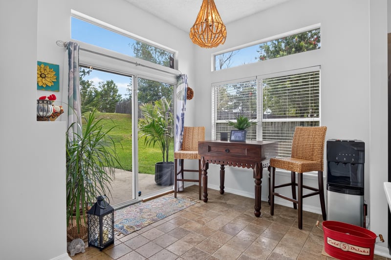 Sunroom nook with windows and high-top table at 1820 Burgess Hill Dr E, Jacksonville, FL