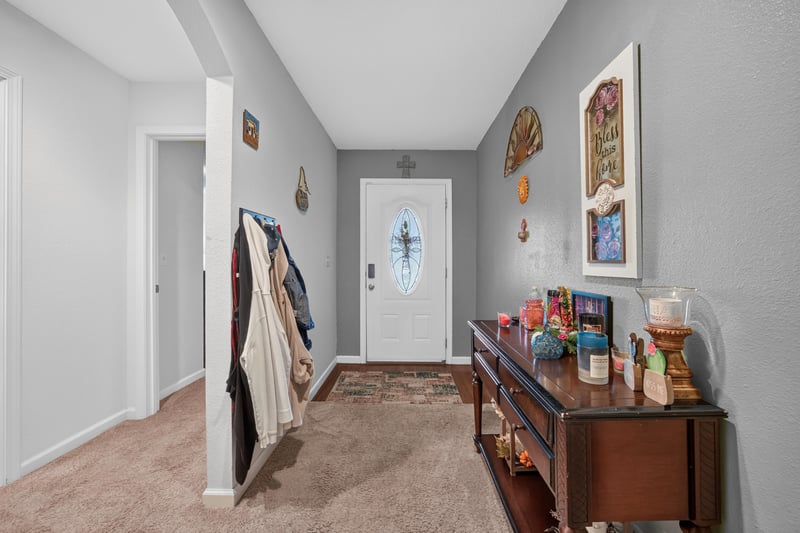 Entry hall view toward front door and wall art at 518 Matecumbe Ct, Macclenny, FL