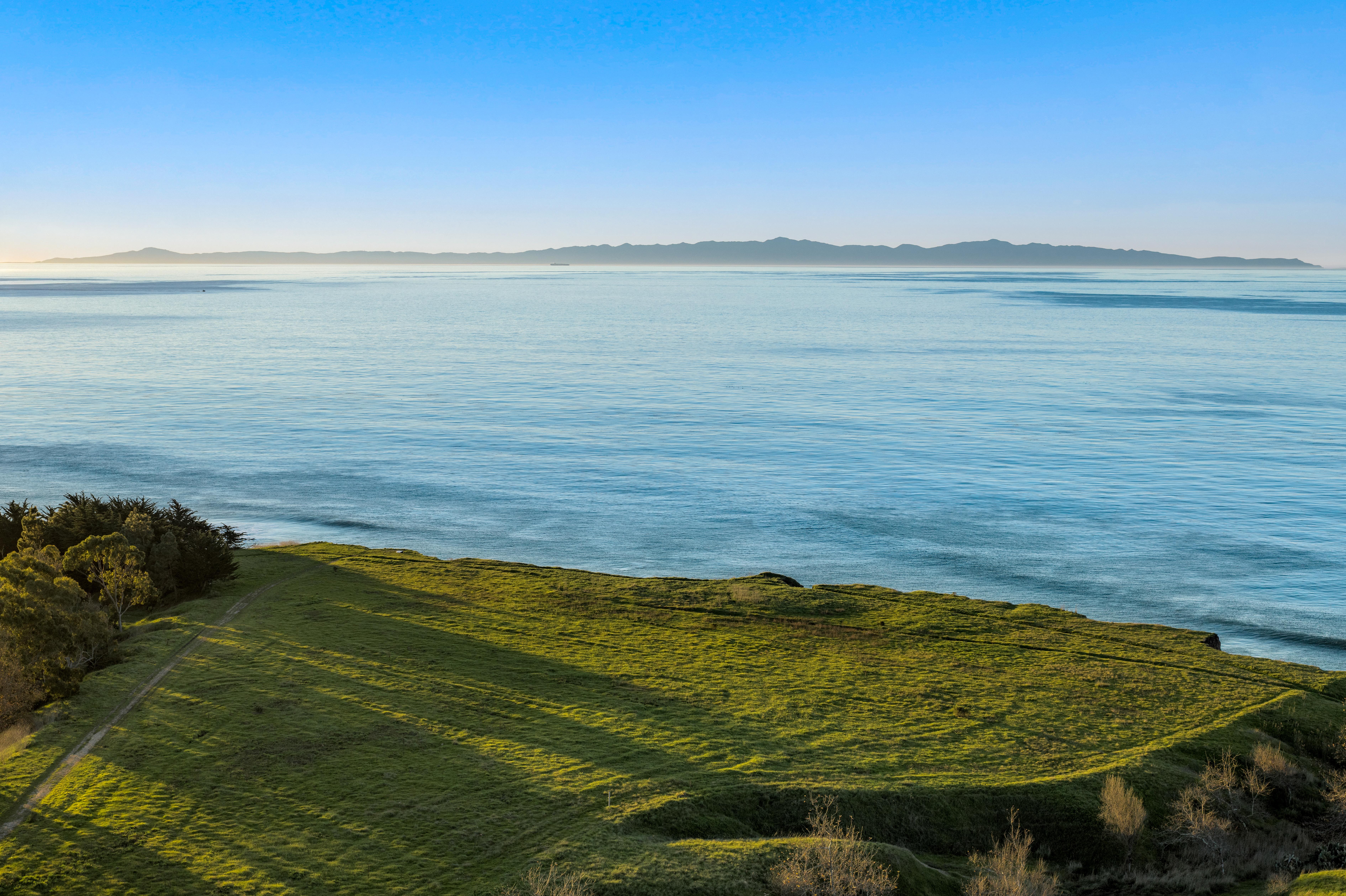 Real estate drone photography elevated perspective of Naples Access Rd, Goleta — Montecito foothills and coastal landscape by VirTour Media