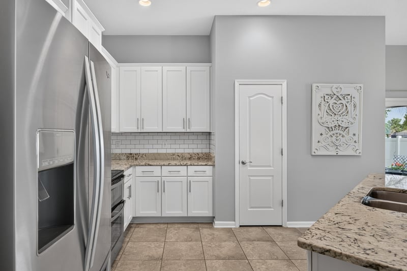Kitchen with stainless refrigerator and pantry door at 85 Amia Dr, St. Augustine, FL 32086