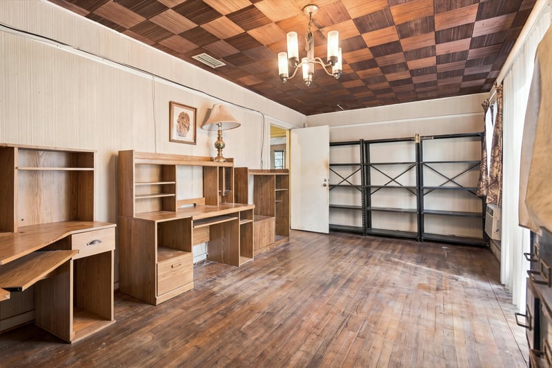 Room with built-in shelving, desk and parquet floor at 1807 Idlewild Ave, Green Cove Springs, FL