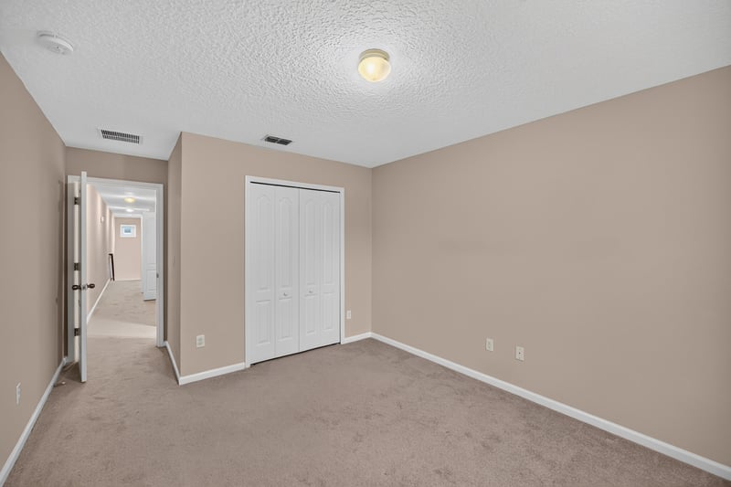 Carpeted hallway with multiple doors at 3762 Hartsfield Forest Cir, Jacksonville, FL 32277