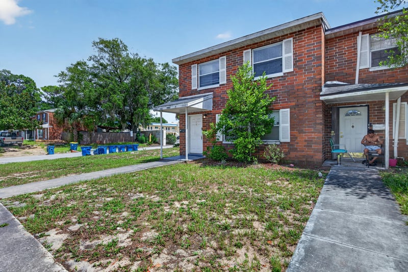 Angled front view showing the shared brick exterior wall at 2658 Trollie Ln apt 1, Jacksonville, FL 32211