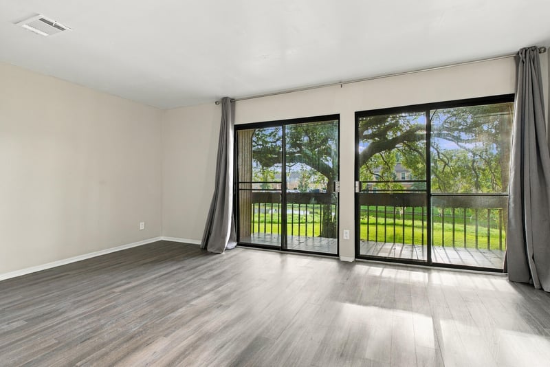 Living room with large sliding glass doors at 7703 Las Palmas Way