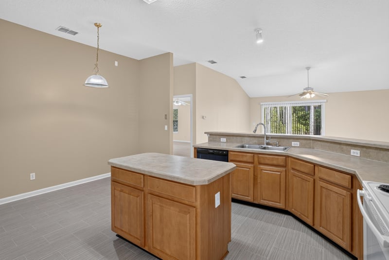 Kitchen island with pendant lighting at 299 John's Creek Pkwy, St. Augustine, FL 32092