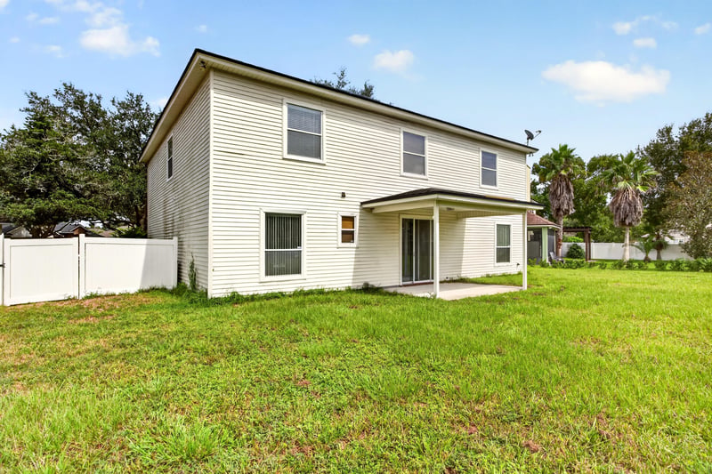 Back exterior with covered porch at 2875 Pebblewood Ln, Orange Park, FL 32065