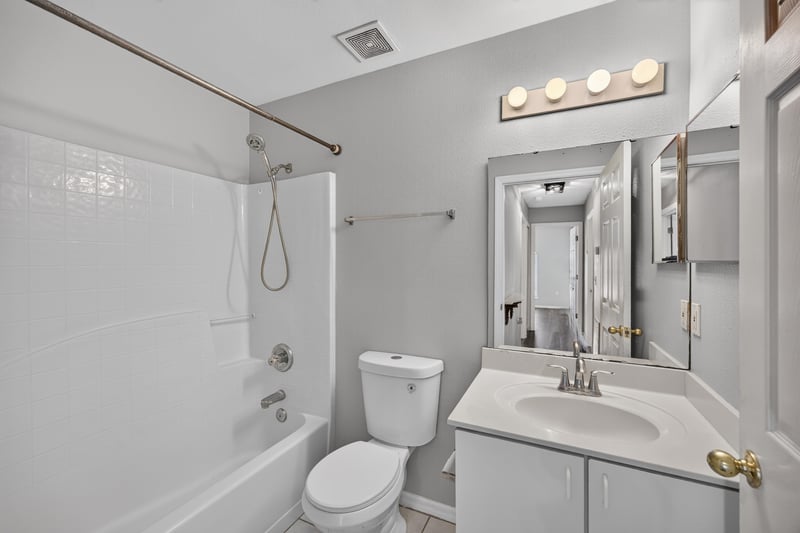 Bathroom with tub and shower combo and single vanity at 7329 Lawn Tennis Ln, Jacksonville, FL