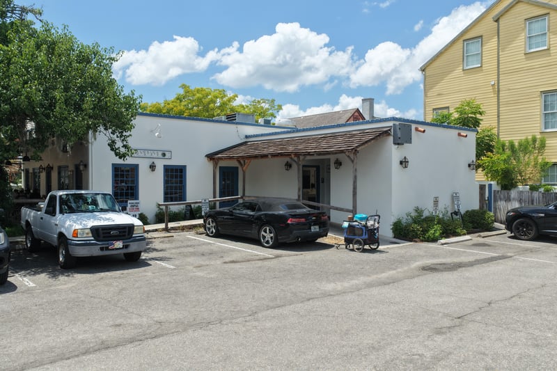 White building exterior with awning and on-site parking at 29 Cuna St, St. Augustine, FL 32084