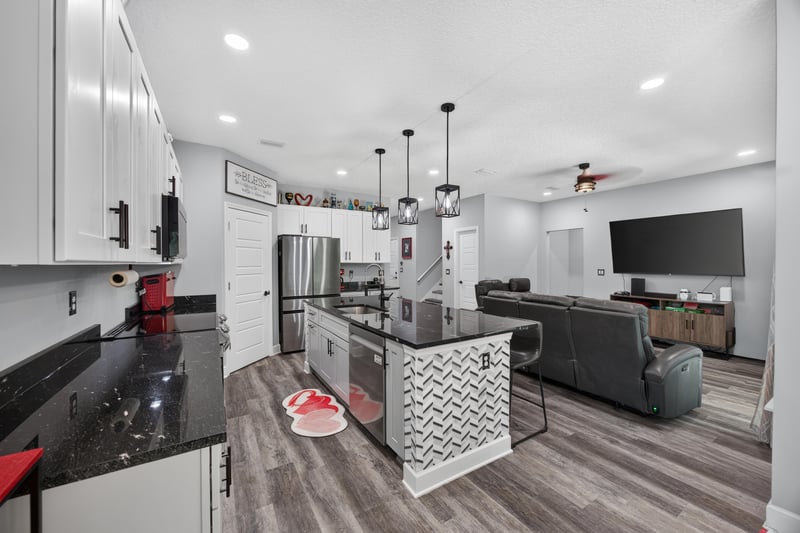 Open kitchen and living area with island seating at 2817 Camel Cir, Middleburg, FL