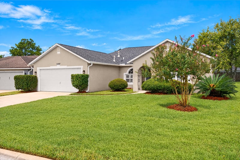 Front exterior with tile roof and landscaping at 11197 Illford Dr