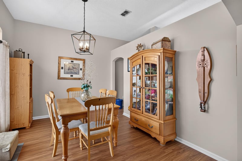 Dining room with china cabinet and wood table at 13514 Las Brisas Way N, Jacksonville, FL