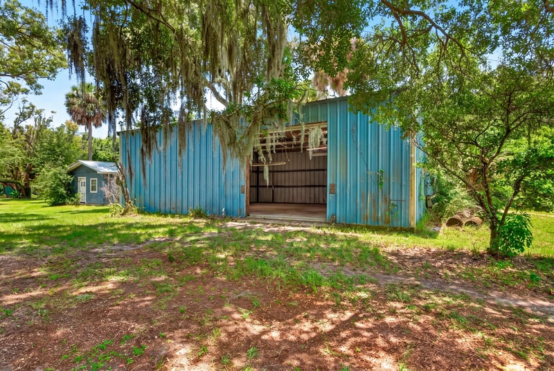 Blue metal barn with sliding doors at 1173 US-17, Satsuma, FL 32189