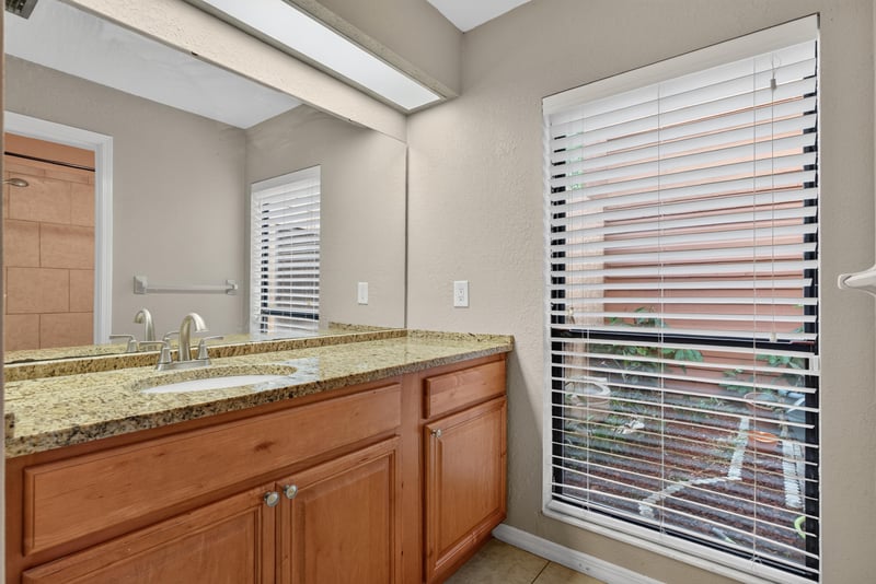 Bathroom vanity with granite counter at 3515 Cormorant Branch Ct, Jacksonville, FL