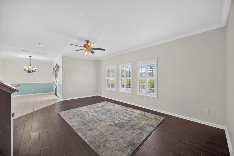 Living area open to the kitchen with ceiling fan at 1493 Greyfield Dr, St. Augustine, FL 32092