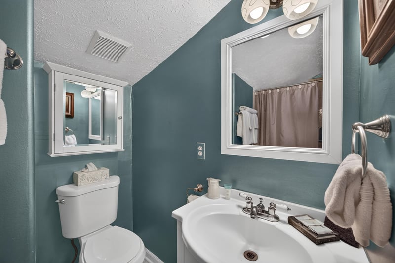 Bathroom with green walls and a pedestal sink at 115 Cordova St, St. Augustine, FL