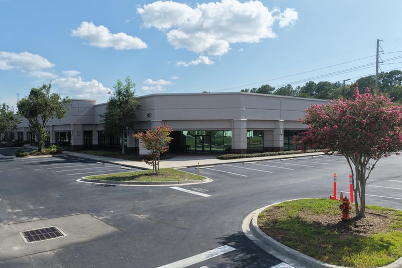 Building front with palm trees and parking at 10550 Deerwood Park Blvd, Jacksonville, FL 32256