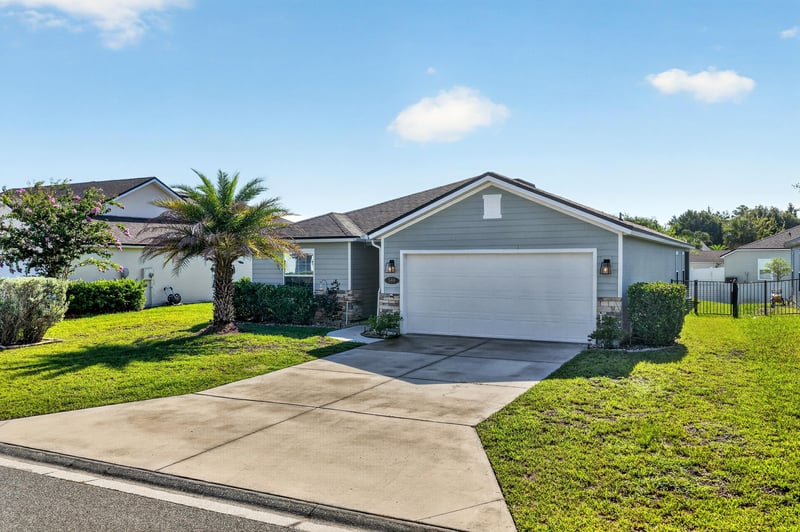 Front exterior with manicured lawn and garage at 589 Seville Pkwy, St. Augustine, FL