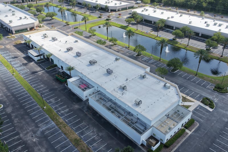 Aerial view of a building roof with signage and parking lot at 10550 Deerwood Park Blvd, Jacksonville, FL 32256
