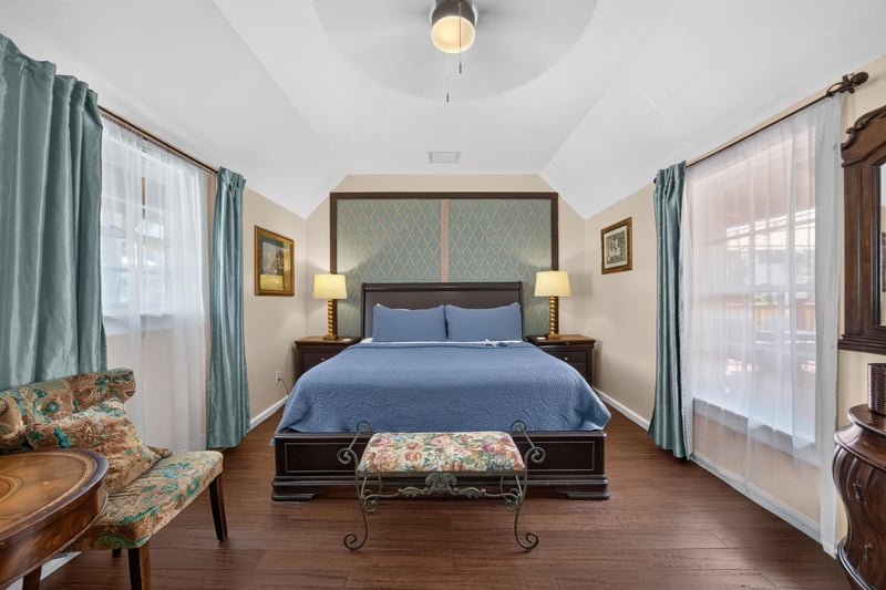 Bedroom with upholstered chairs and blue bedding at 115 Cordova St, St. Augustine, FL