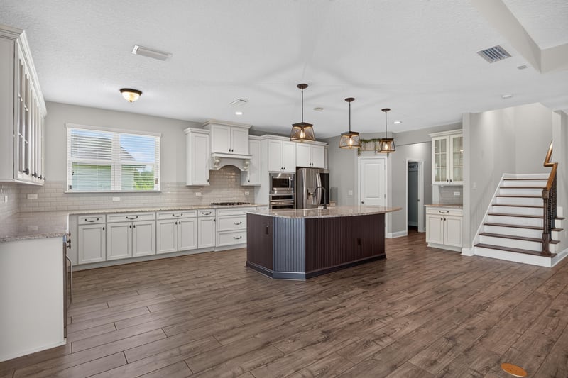 Kitchen island with staircase visible in background at 53 Lumen Ct, St. Augustine, FL 32095