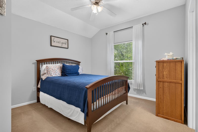 Bedroom with navy bedding and carpet at 2304 Spring Hill Ct, Orange Park, FL