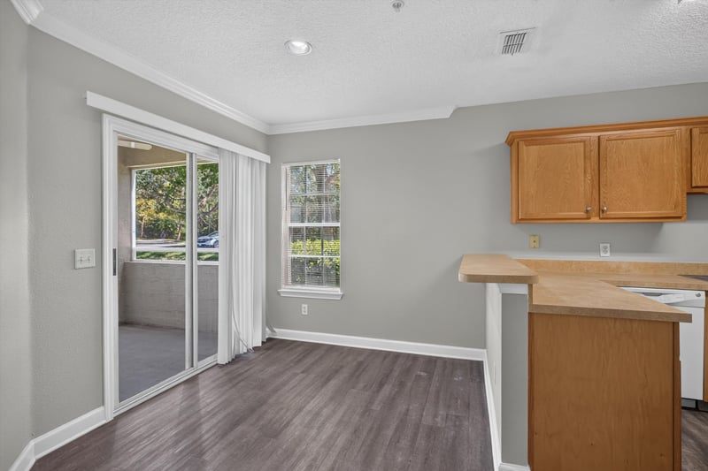 Living room with sliding glass door at 1701 The Greens Way 1415, Jacksonville Beach, FL 32250