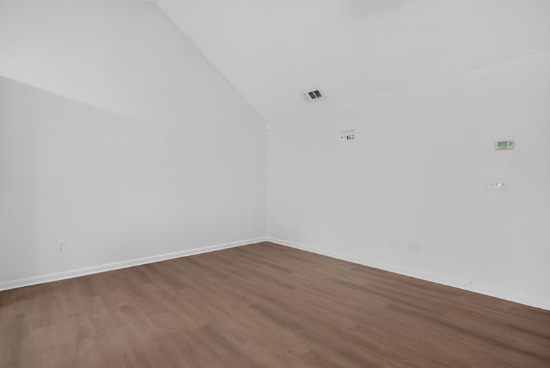 Living room with vaulted ceiling and wood-look floor at 8177 Virgo St, Jacksonville, FL 32216