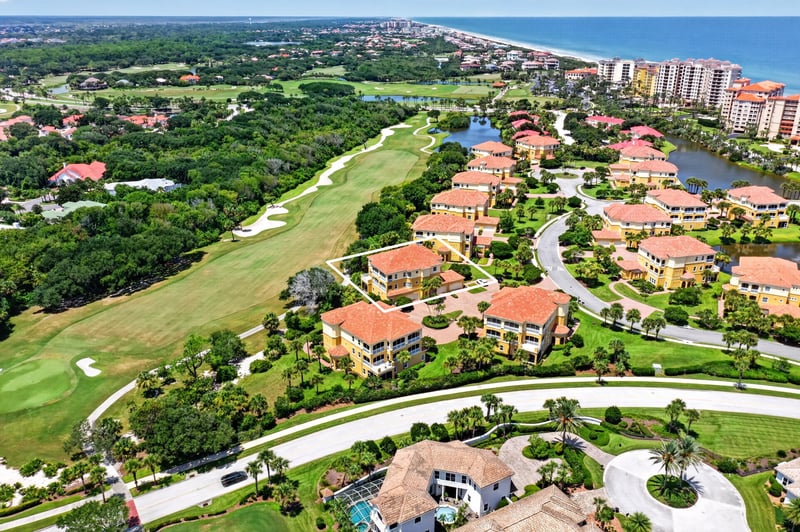 Aerial of golf course and pond in the community in Palm Coast, FL