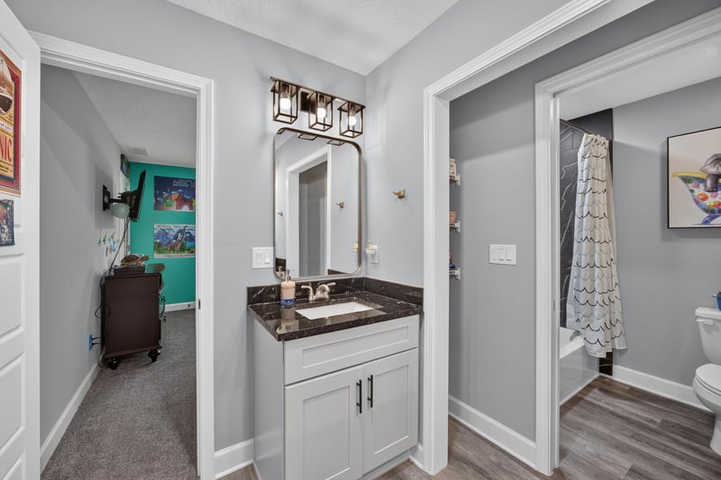 Bathroom vanity with black countertop at 2817 Camel Cir, Middleburg, FL