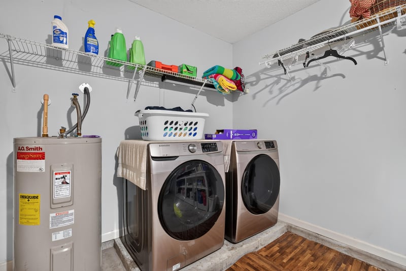 Laundry room shelving with storage bins at 3067 Wavering Ln, Middleburg, FL 32068