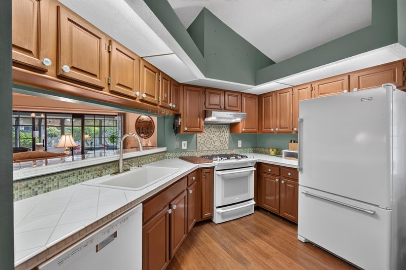 Kitchen with oak cabinets and white appliances at 4837 Pareja Ct, Jacksonville, FL 32225