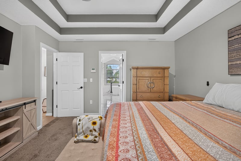 Bedroom with tray ceiling and TV stand at 2125 Blue Heron Cove Dr, Orange Park, FL 32003