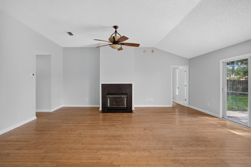 Living room with fireplace and wood floors at 456 Bay Point Way N, Jacksonville, FL 32259