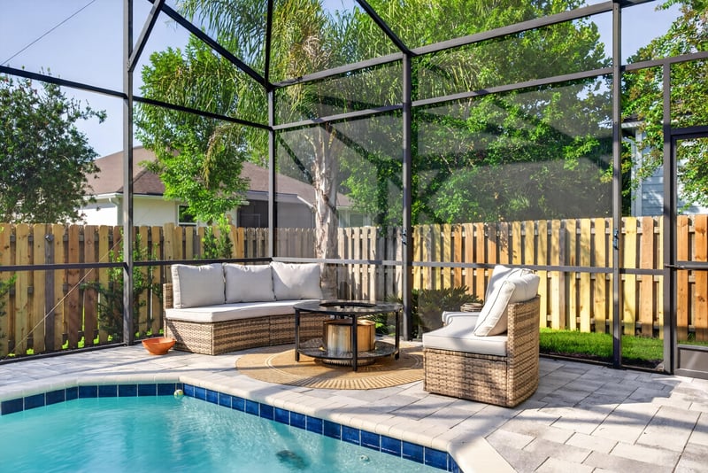 Pool patio with seating along a fenced yard at 3328 Southern Oaks Dr, Green Cove Springs, FL 32043