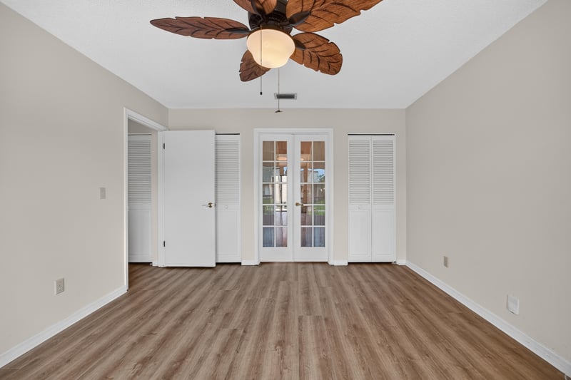 Empty room with french doors and wood floors at 3407 Fairbanks Grant Rd N, Jacksonville, FL 32223