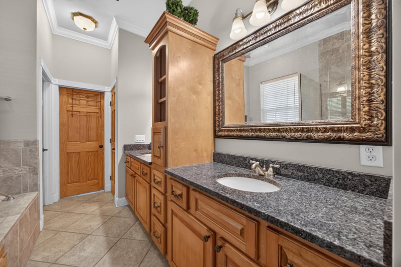 Primary bath vanity with framed mirror at 1735 Hagans Ridge Ct