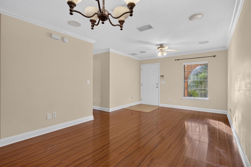 Empty living space with window and ceiling fan at 353 Redwood Ln