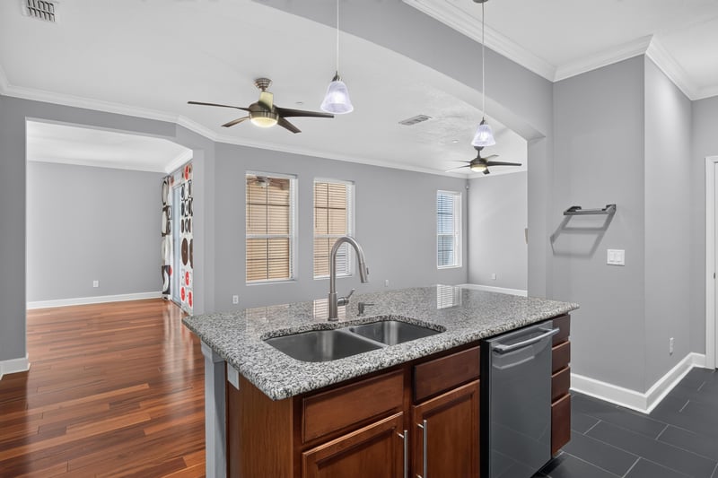 Kitchen and dining area with island and wood cabinets at 6217 Eclipse Cir, Jacksonville, FL 32258