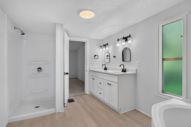 Primary bathroom with walk-in shower and vanity at 55520 Jewel-Thomas Rd, Callahan, FL 32011