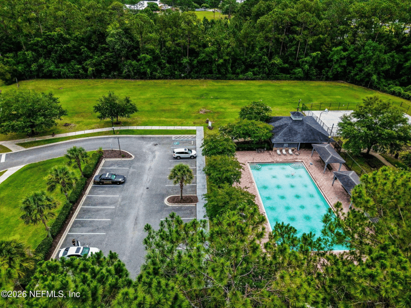 Aerial view of community pool and parking area in Adams Lake, Jacksonville, FL