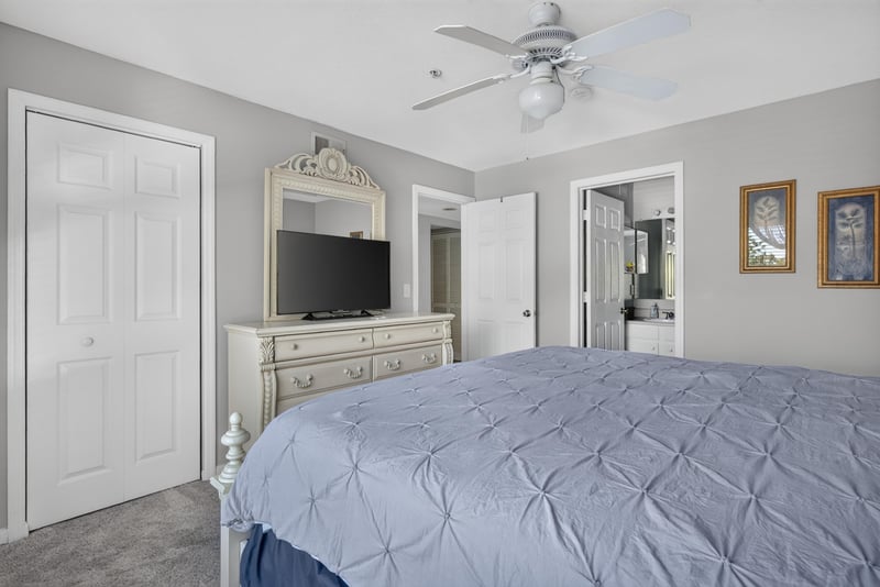 Primary bedroom with bed, mirror and dresser at 206 16th St, St. Augustine, FL 32080