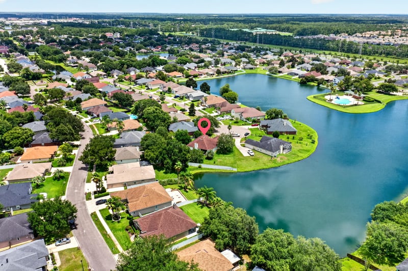 Aerial view of homes along a winding lake in Windsor Chase
