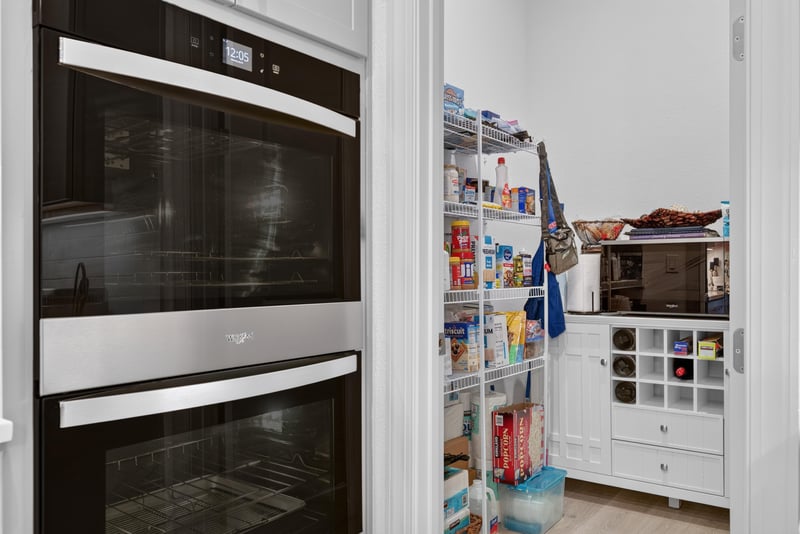 Built-in wall ovens and walk-in pantry shelving at 785 Back Creek Dr, St. Augustine, FL 32092
