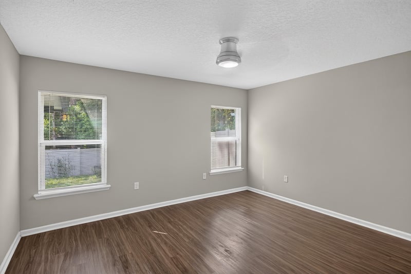 Living room with wood floors and windows at 7118 Preston Pnes Trl, Jacksonville, FL